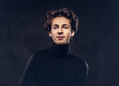 Man in a turtleneck looking pensive