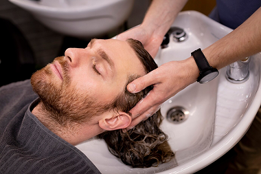 Man with curly hair looking up