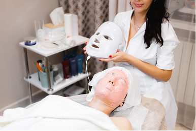 Woman receiving facial treatment in spa